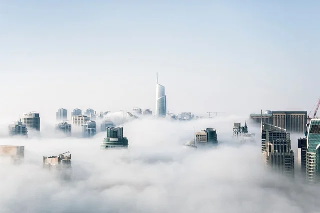 Skyscrapers covered in fog.